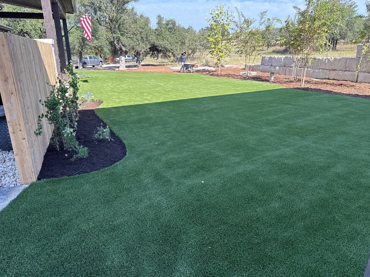 Landscape estimating software showing artificial turf line items including infill, bender board, and installation labor