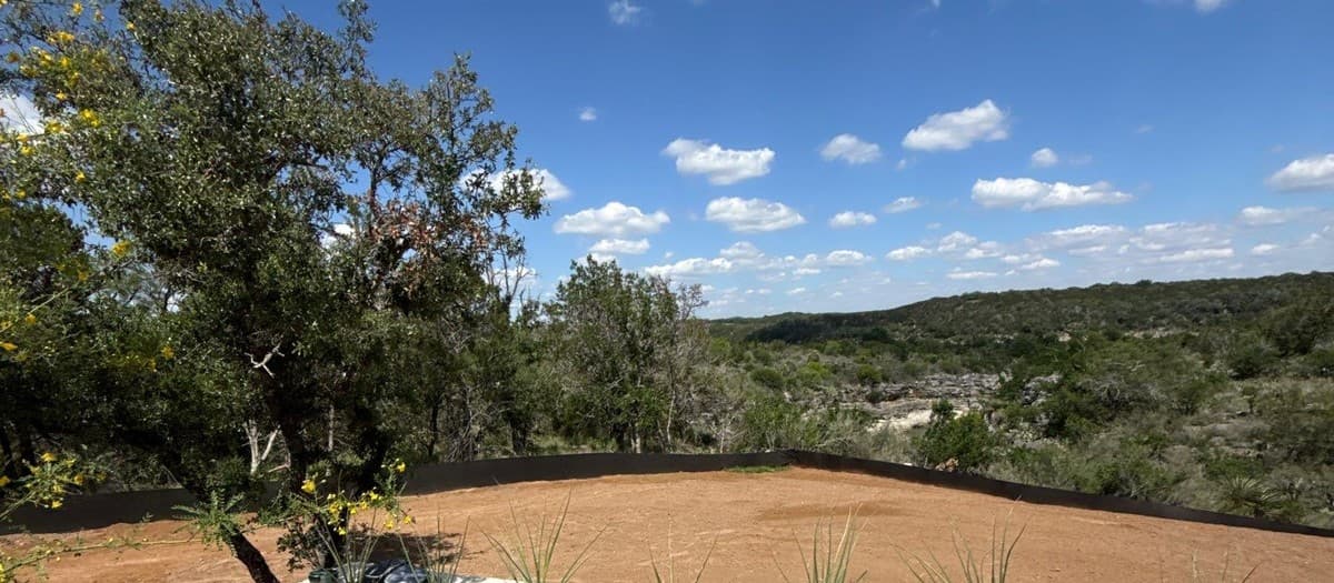 Before and after landscape photos showing transformation from bare yard to completed hardscape project