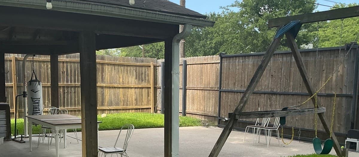 Pergola built on existing concrete patio showing post base anchoring and beam attachment details