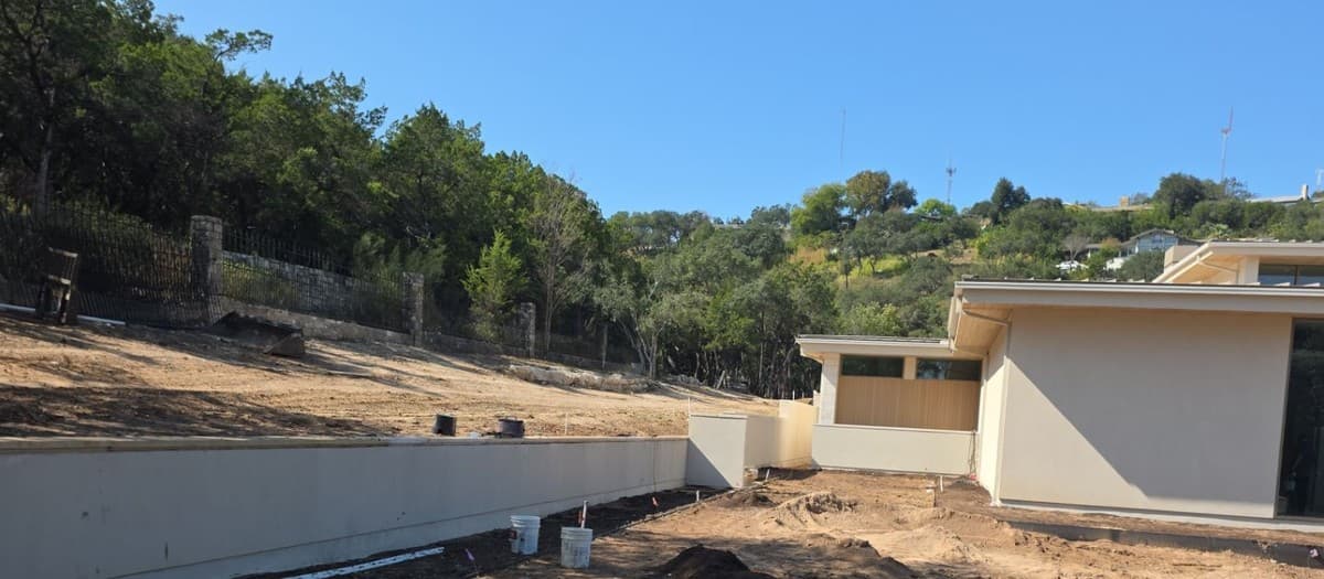 Retaining wall over 4 feet tall showing geogrid reinforcement, drainage aggregate, and block coursing