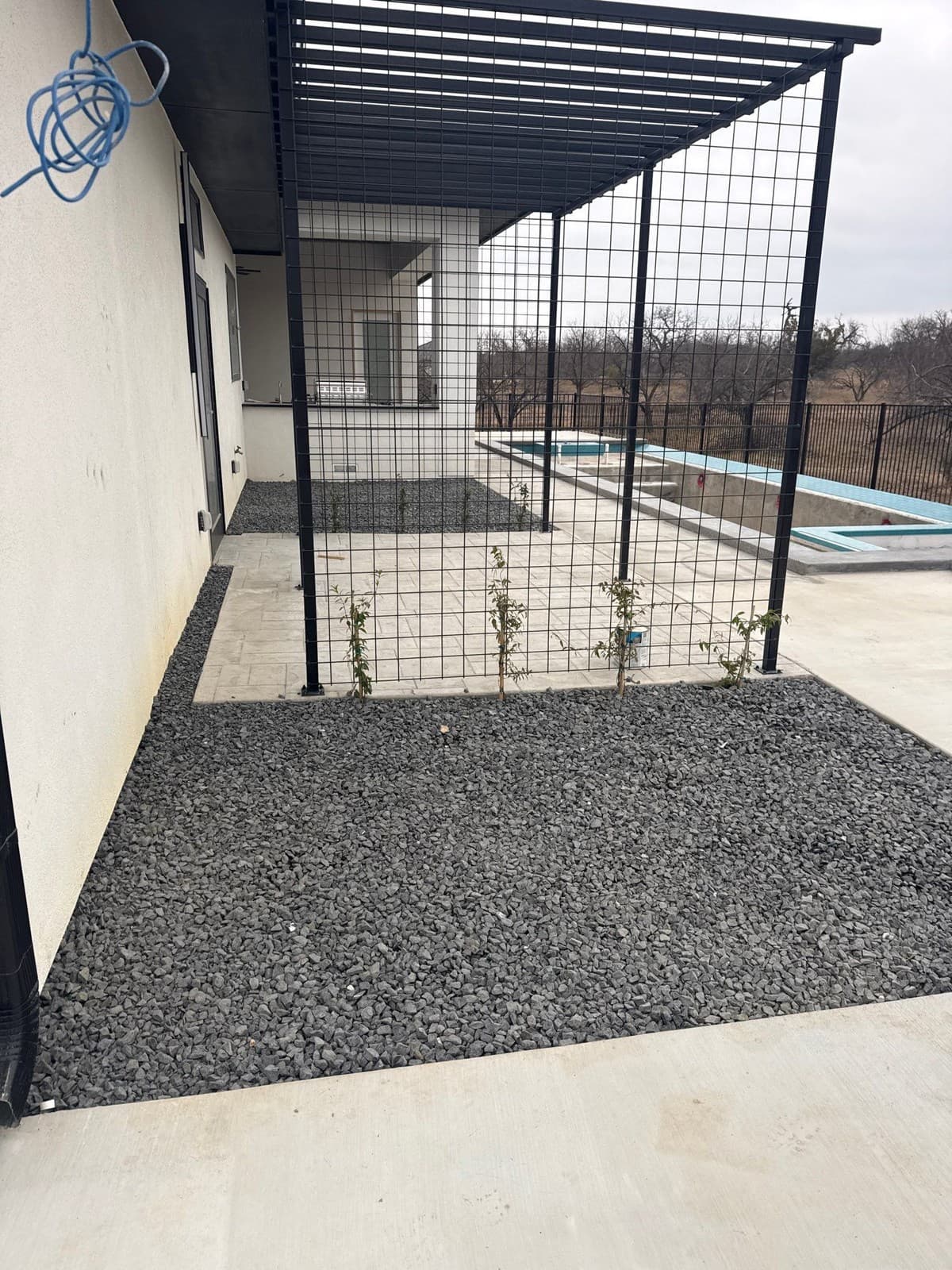 Steel fence post base plate welding and concrete footing detail for residential landscape installation