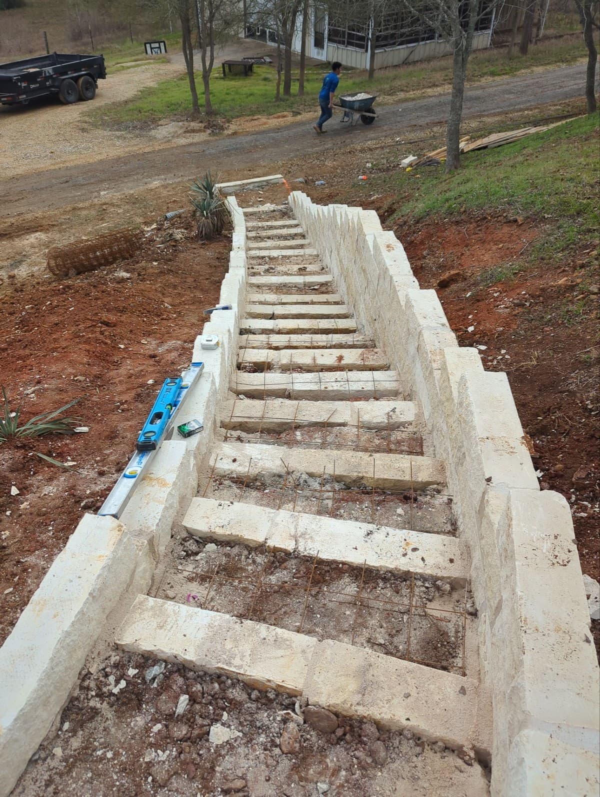 Geogrid installation detail showing wall block, geogrid embedment depth, and reinforced backfill zone