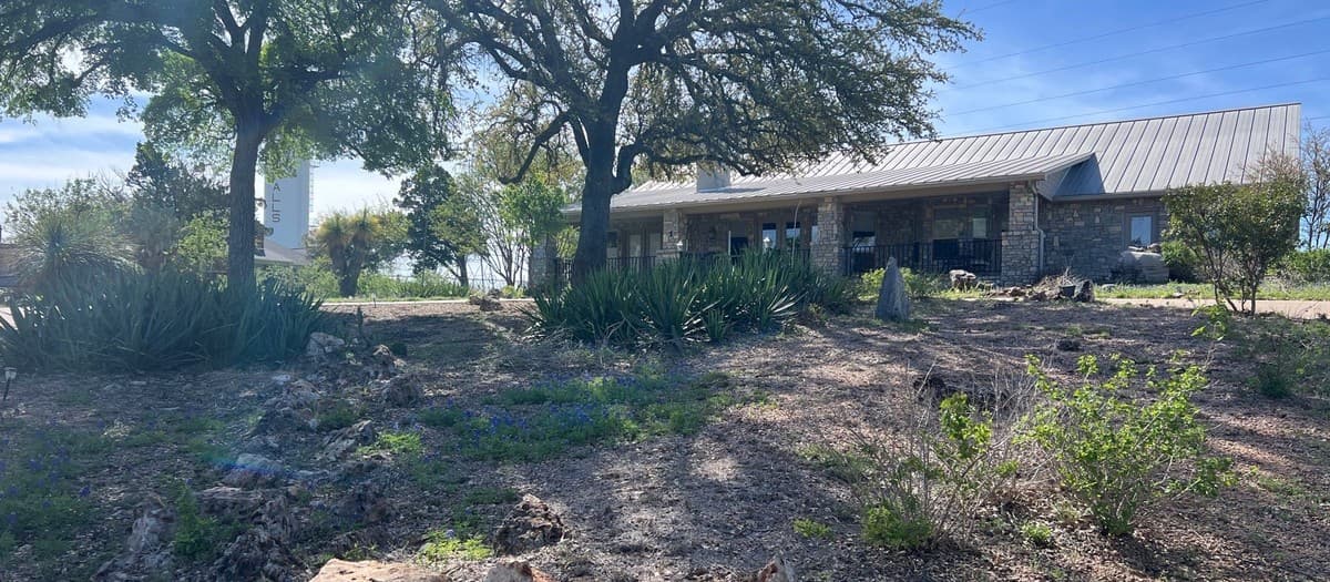 How to estimate a dry creek bed — rock quantity, excavation depth, filter fabric, and labor cost breakdown