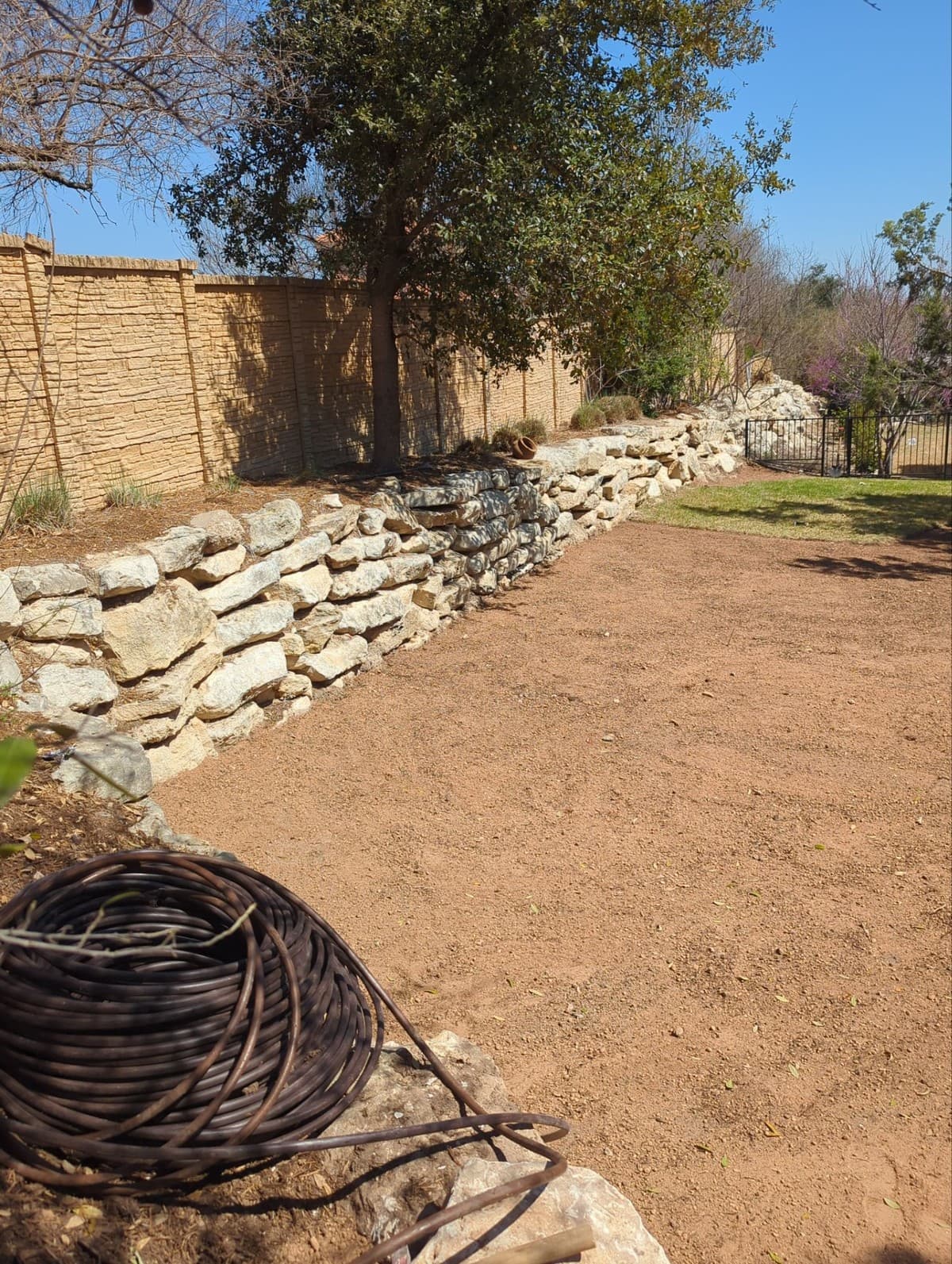 Retaining wall estimating breakdown showing materials and labor per linear foot by wall height