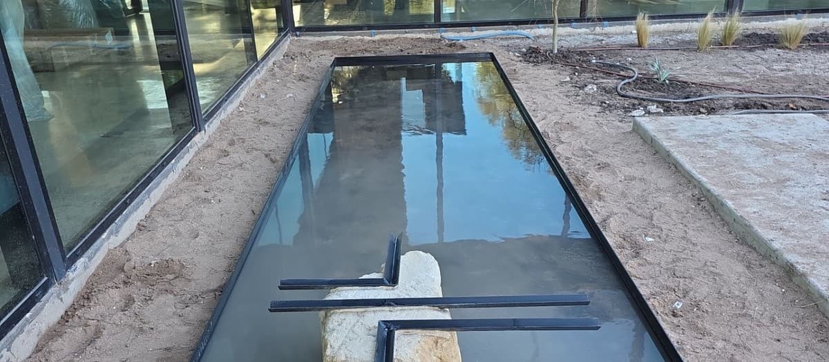 Water feature installation cost estimating — pump, basin, rock, liner, and plumbing breakdown