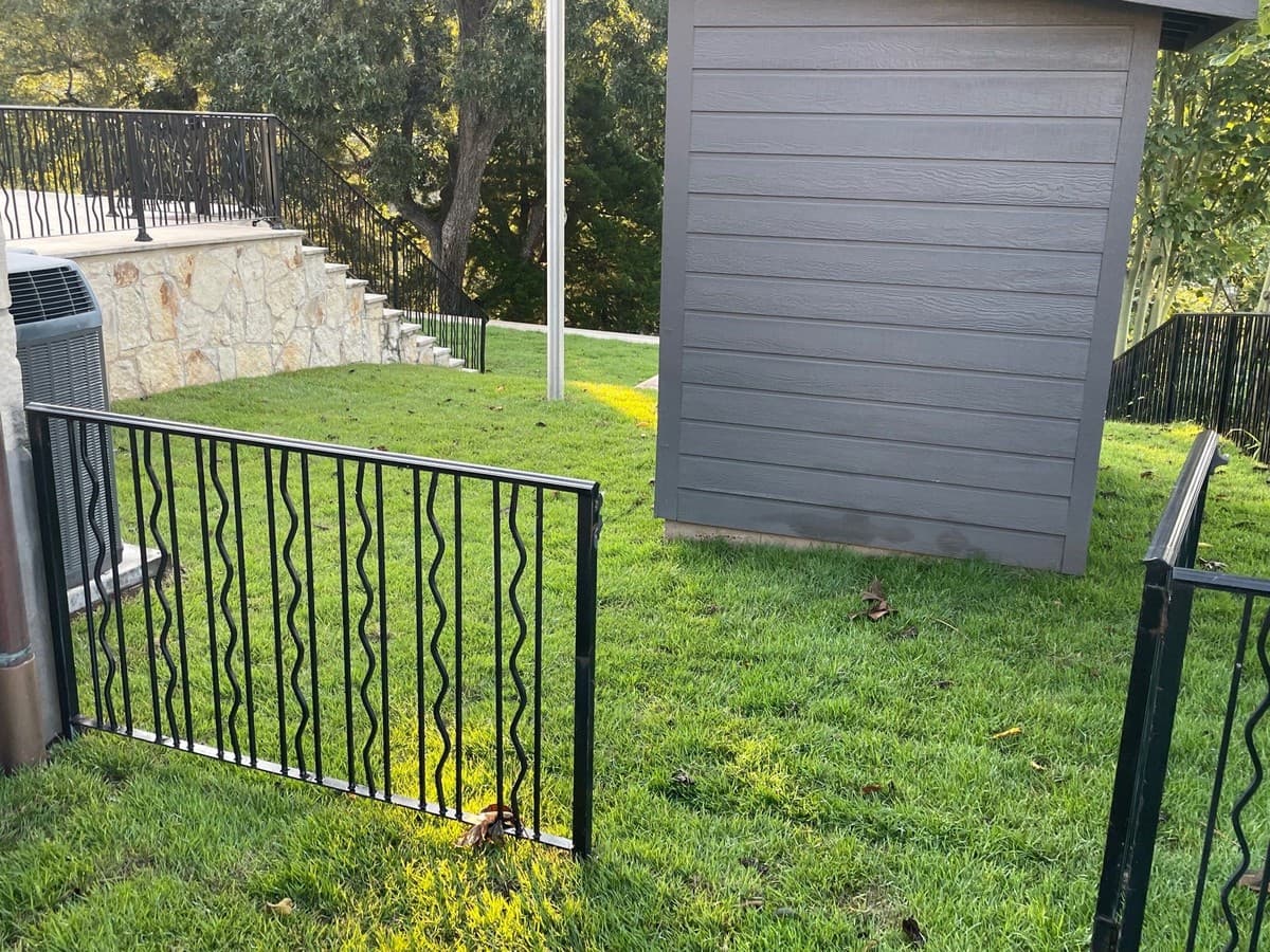 Steel gate hinge and latch detail showing post embedment depth, horizontal brace, and gate alignment