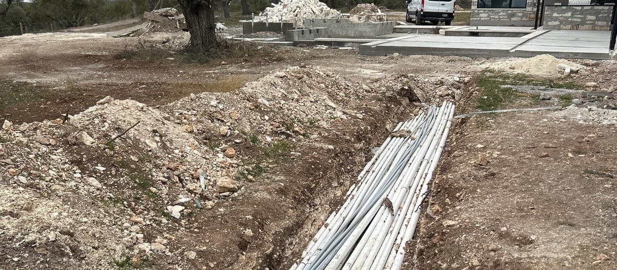 When landscape projects require a licensed electrician or plumber — code triggers and subcontractor coordination
