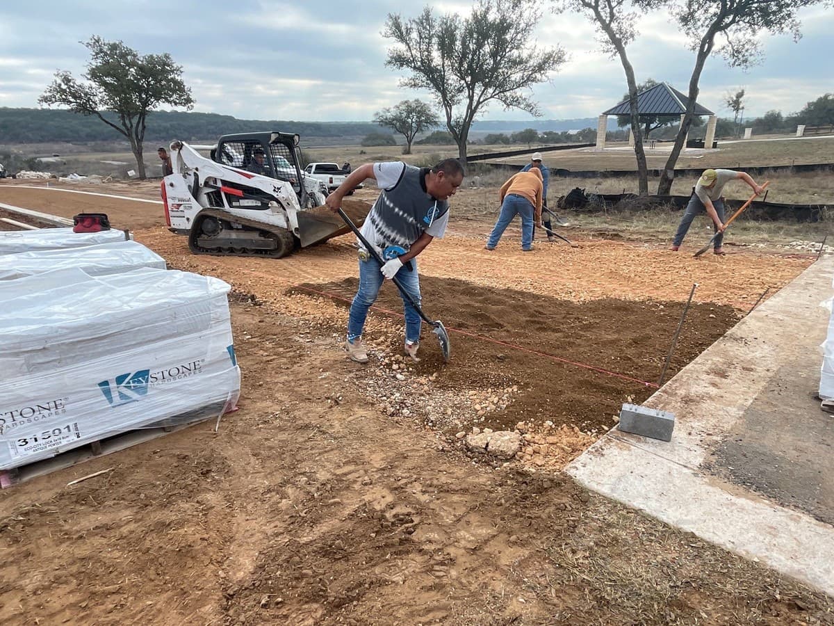Paver patio proposal scope section showing excavation, base stone, bedding sand, pavers, and edge restraint lines